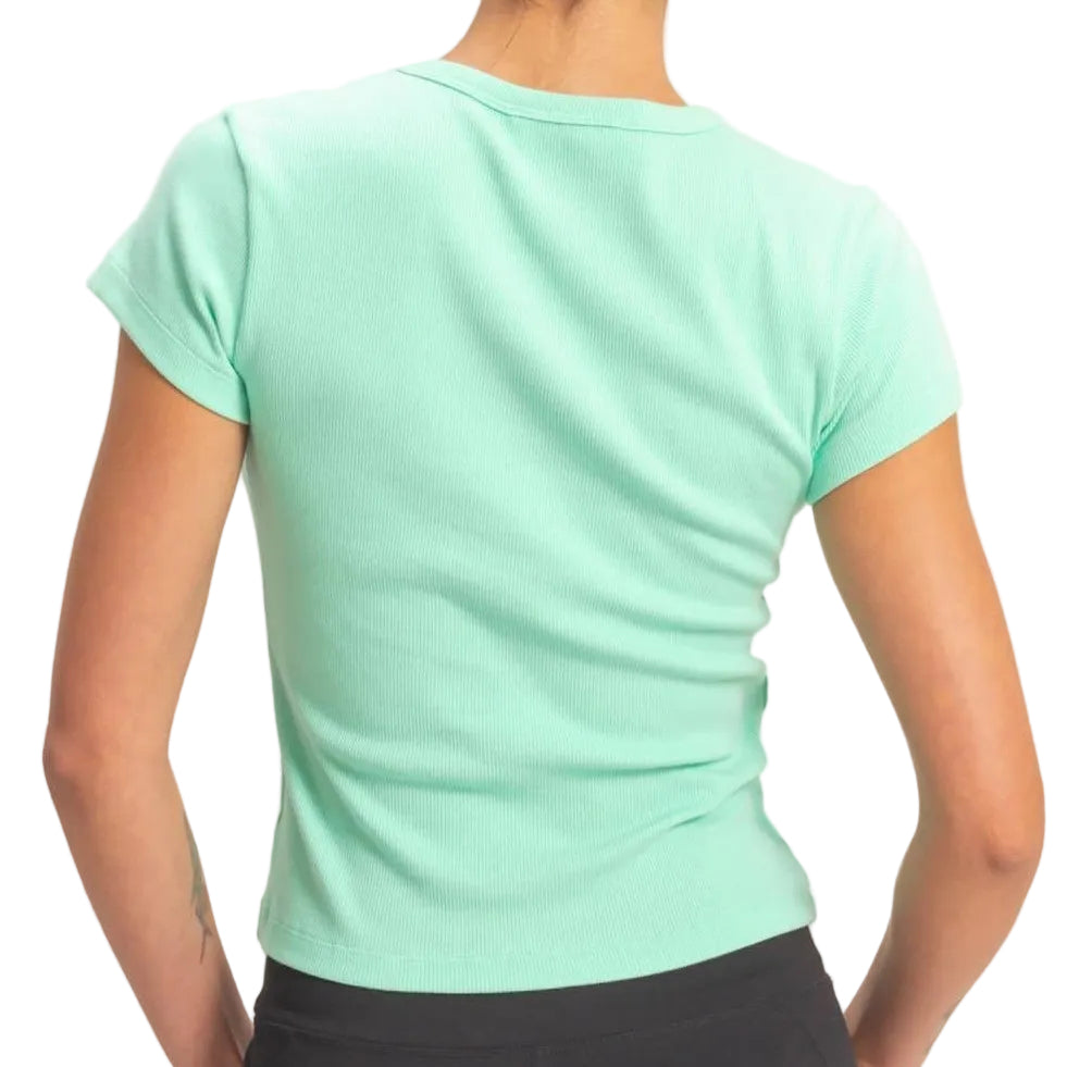 Person wearing a green t-shirt and black shorts on a plain background