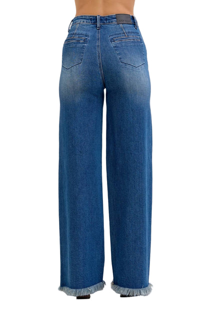 Blue jeans with frayed cuffs on a light gray background