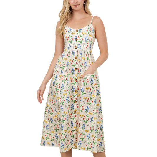 Woman wearing a floral dress standing in a room with plants.