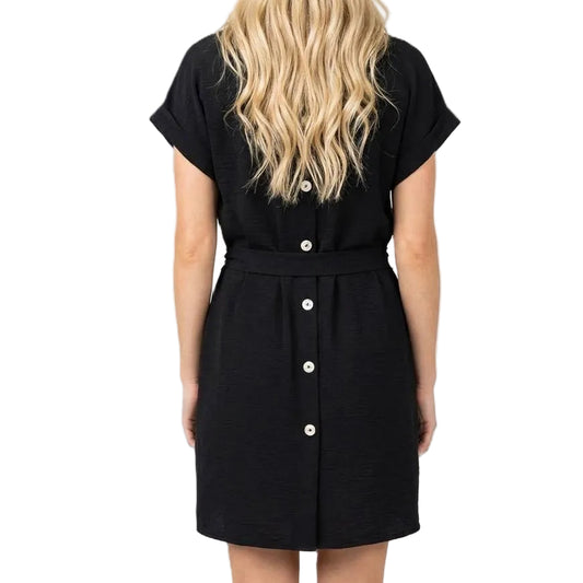 Black dress worn by a person with blonde hair on a white background