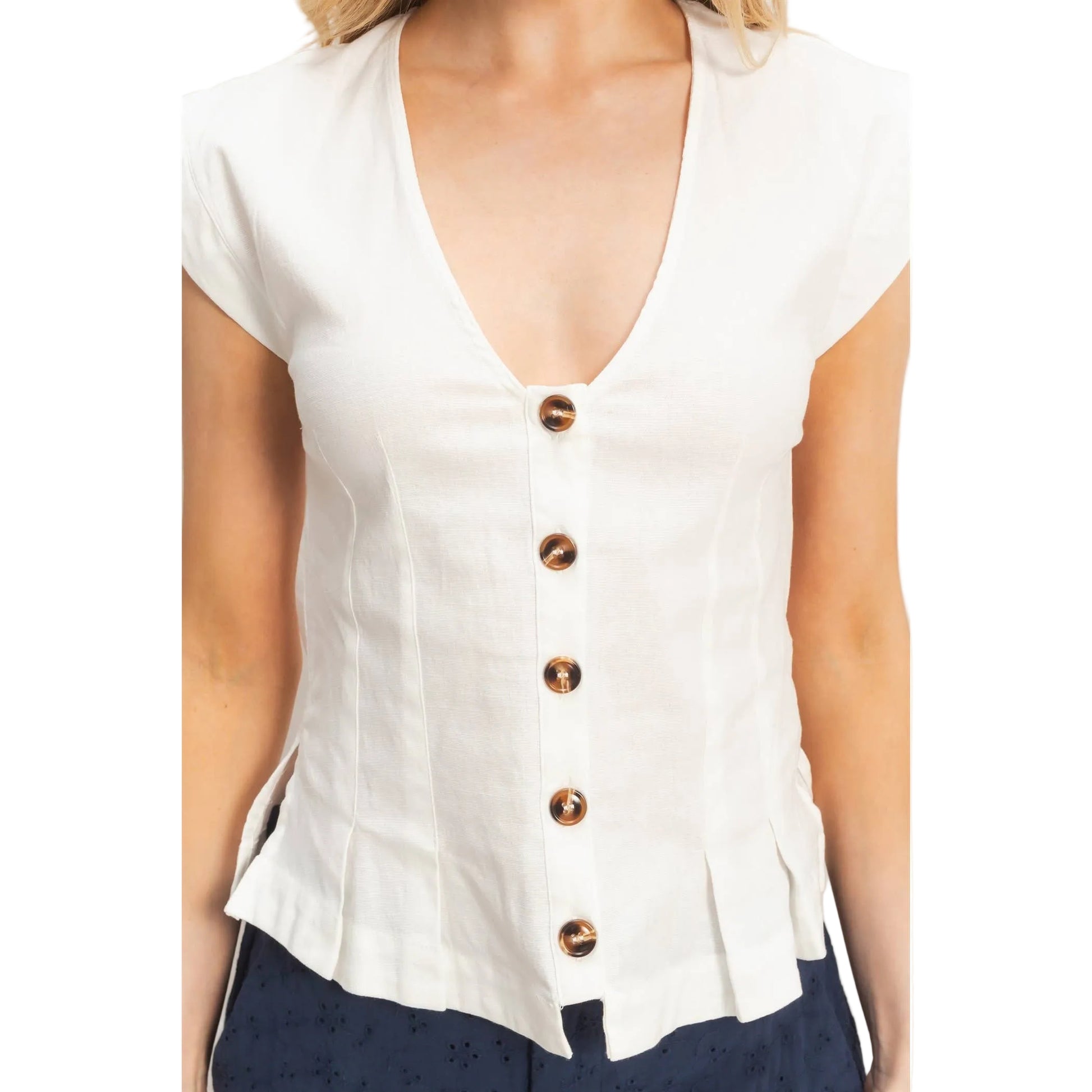 White blouse with copper buttons on a plain background