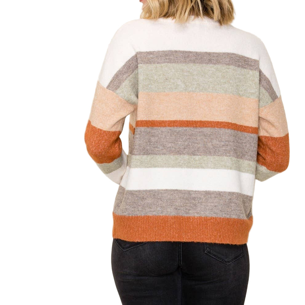 Woman wearing a striped sweater with a neutral background