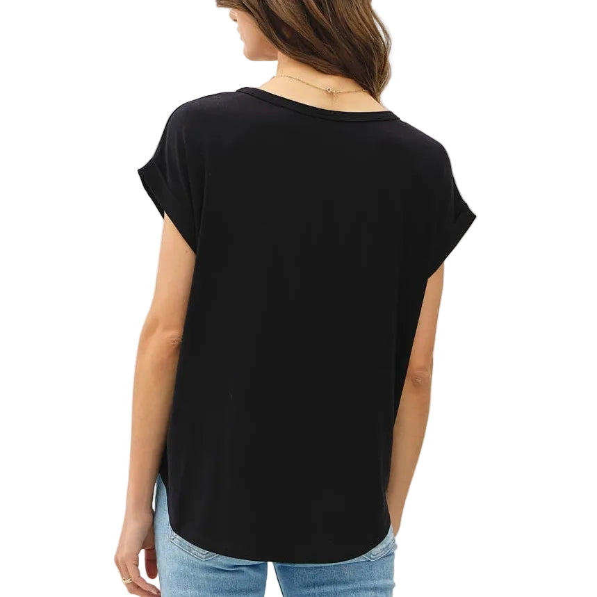 Person wearing a black t-shirt and light blue jeans on a white background