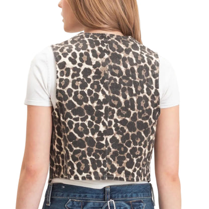 A woman shown from the back wearing a sleeveless leopard-print vest over a white t-shirt and blue jeans, against a plain light beige background.
