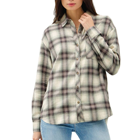 Woman wearing a plaid shirt and jeans on a white background