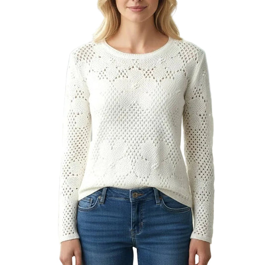 Woman wearing a white sweater and blue jeans in an office setting