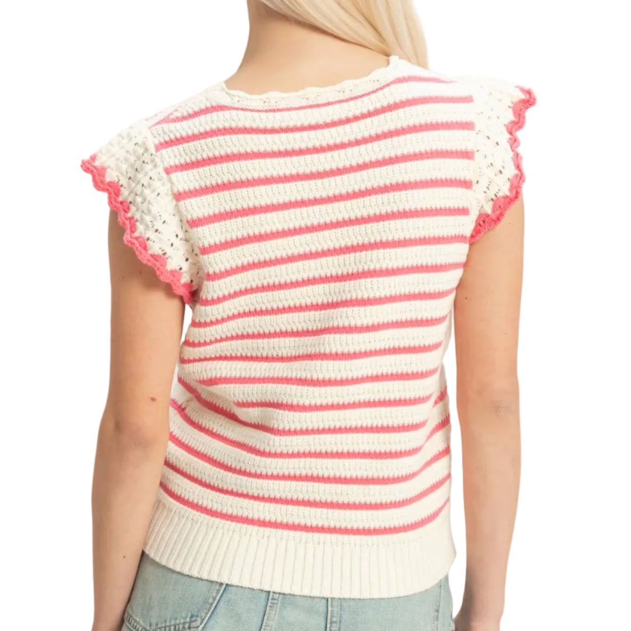 Woman wearing a red and white striped sweater with ruffled sleeves on a plain background