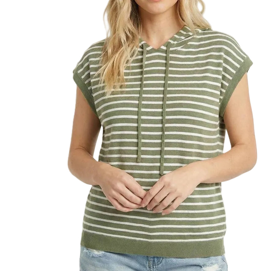 Woman wearing a green and white striped sleeveless hoodie with denim shorts on a beige background