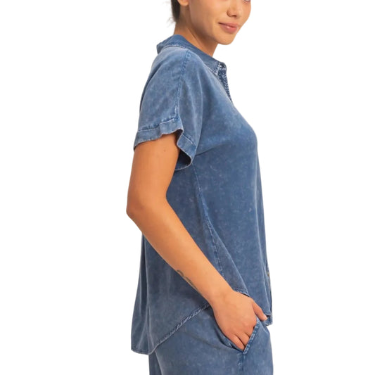 Woman wearing a blue denim outfit against a plain background