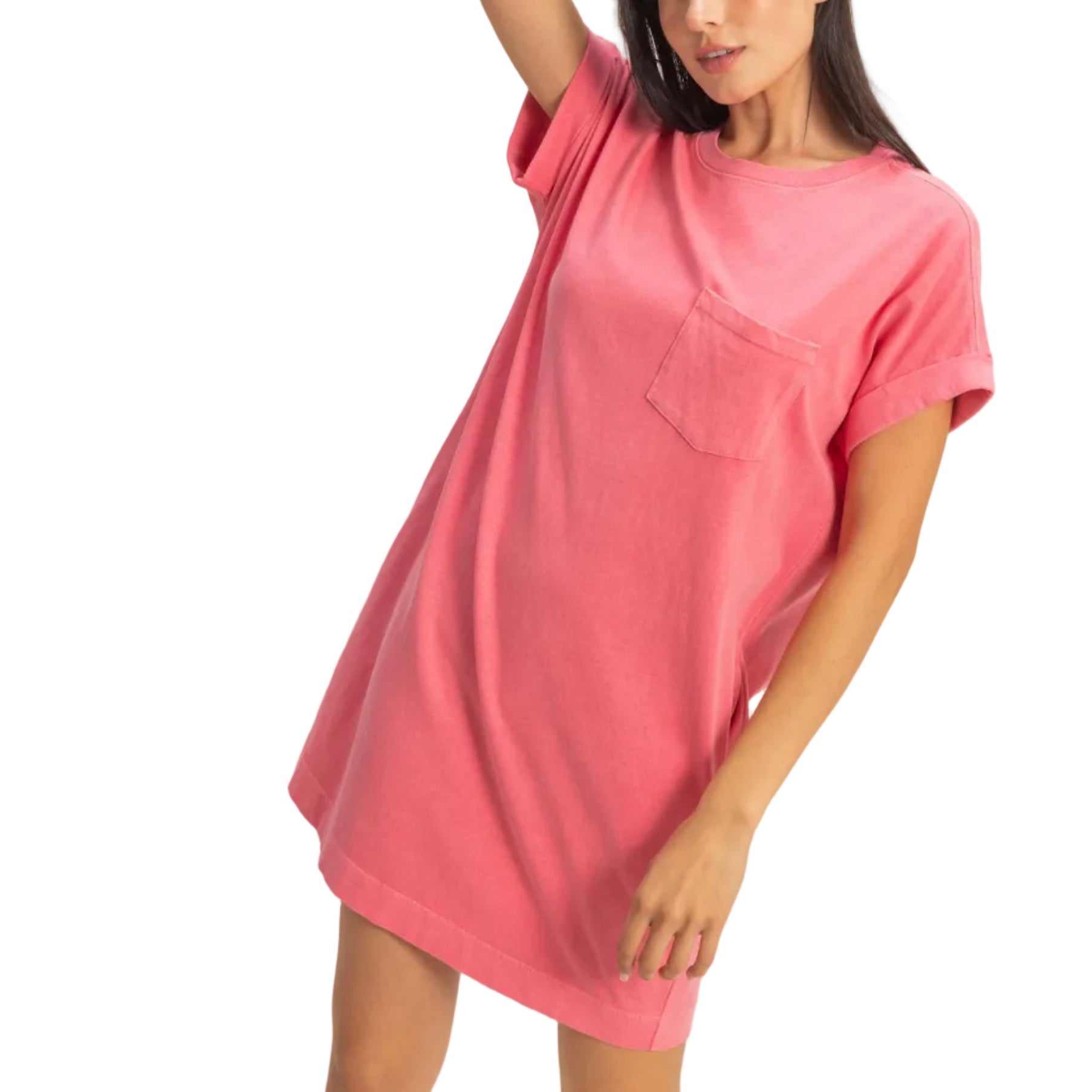 Woman wearing a pink t-shirt dress against a plain background