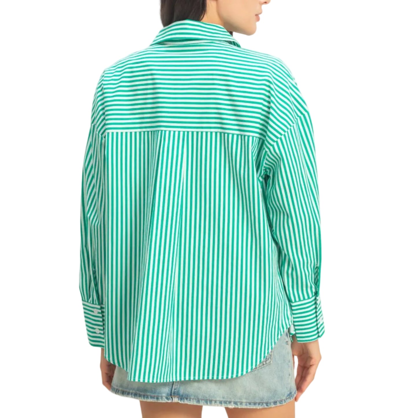 Woman wearing a green and white striped shirt against a plain background