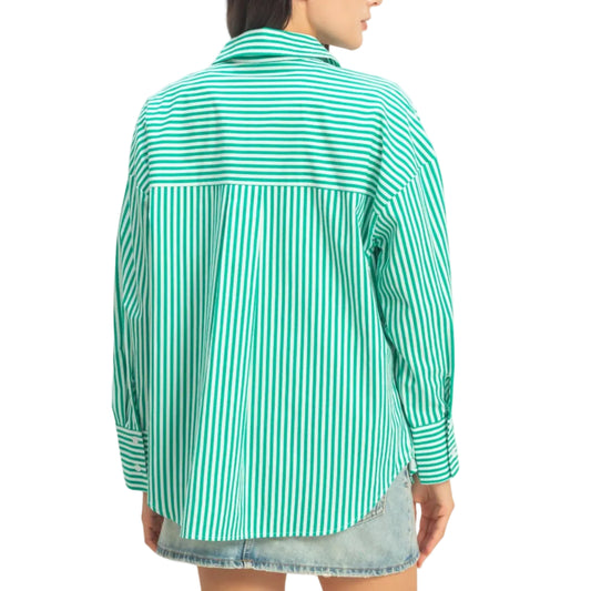 Woman wearing a green and white striped shirt against a plain background