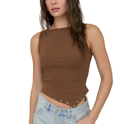 Woman wearing a brown sleeveless top with studded details and light blue denim shorts on a white background