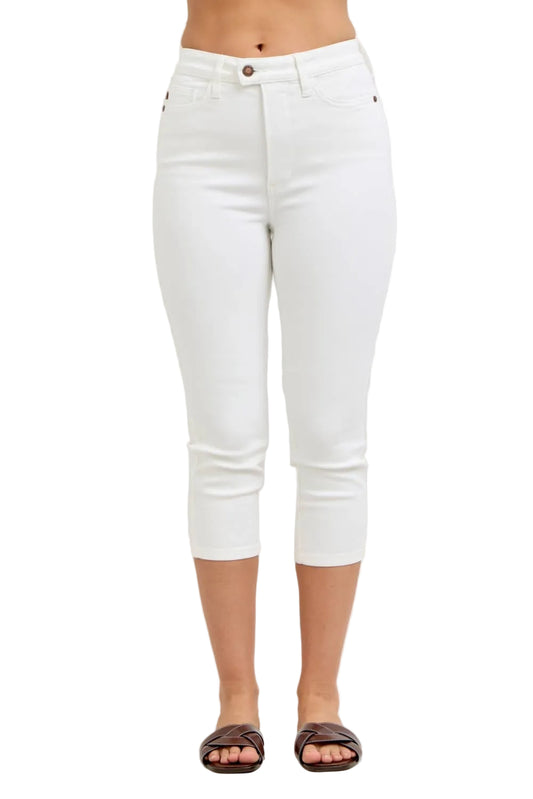 White jeans worn by a person on a plain background