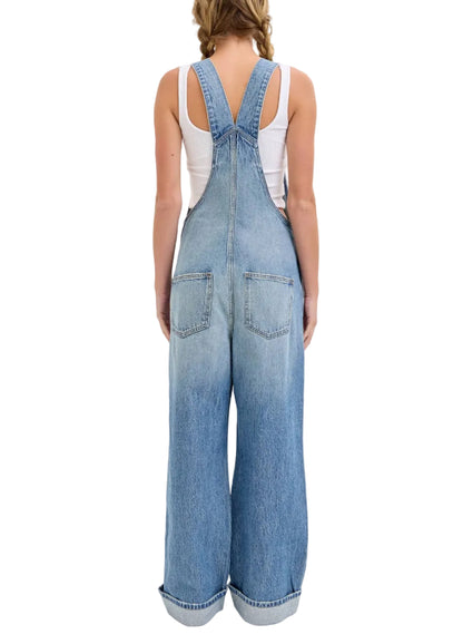 Person wearing blue denim overalls on a white background