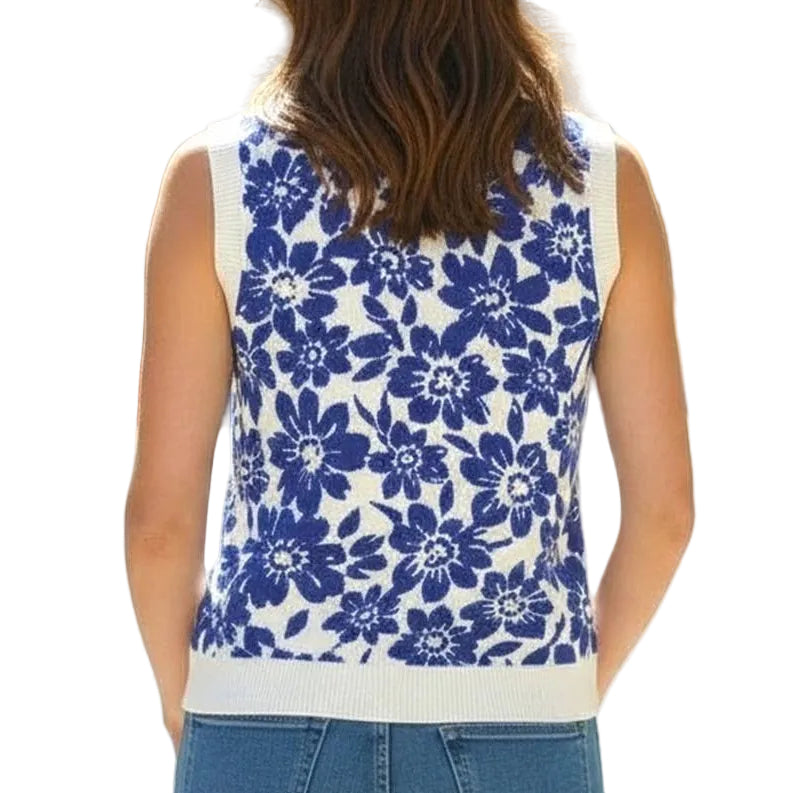 Woman wearing a blue floral sleeveless top with a blurred cityscape background