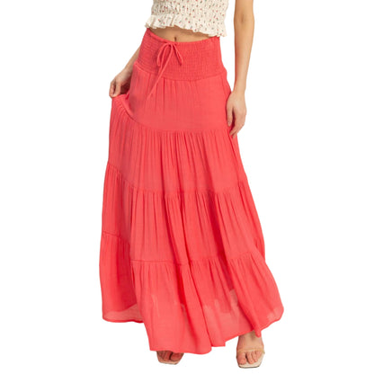 Coral tiered skirt worn by a person on a plain background