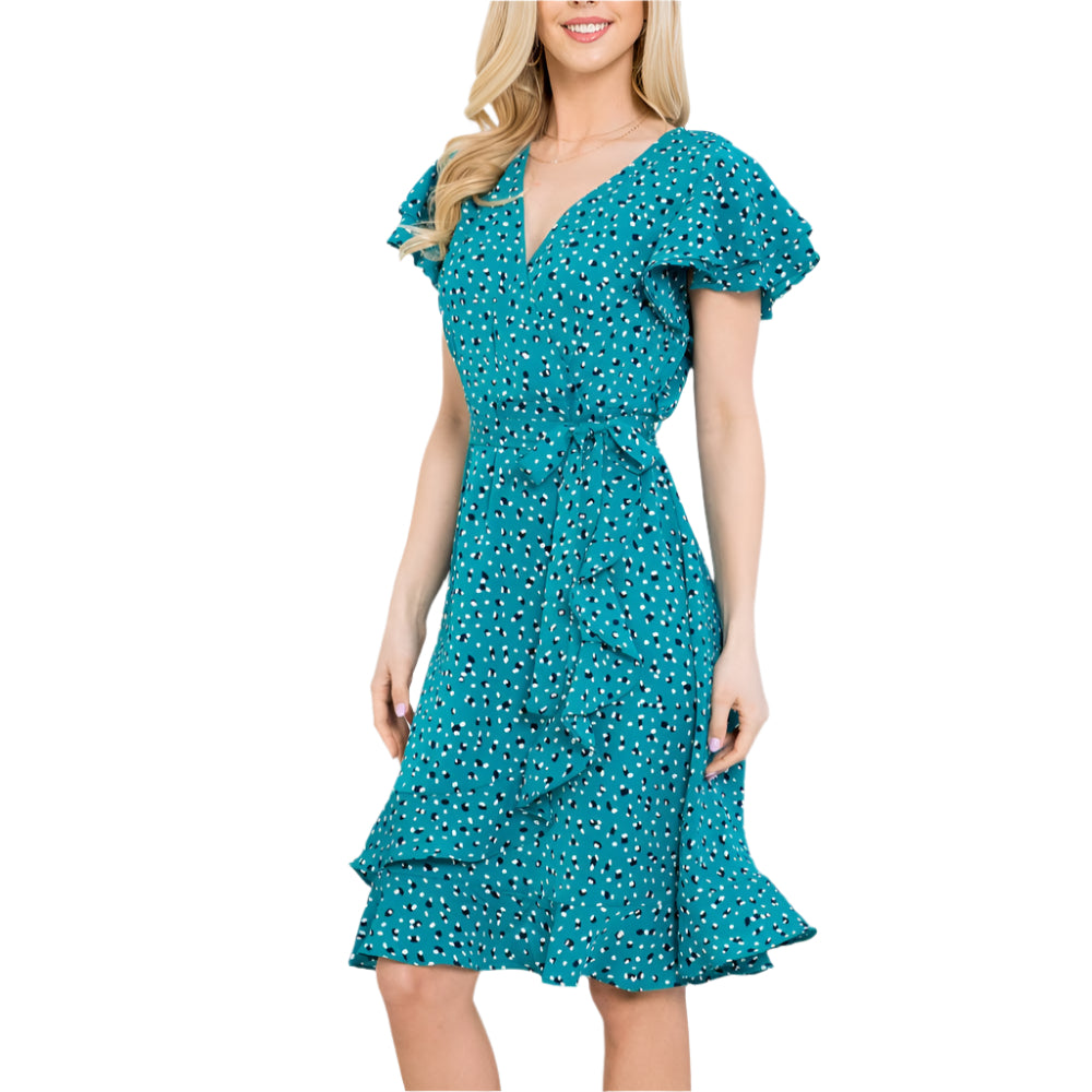 A woman wearing a teal dress with a white background 