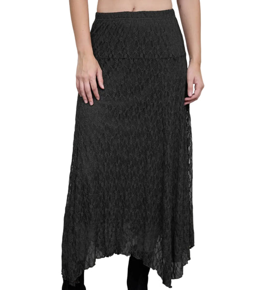 A model wearing a black lace midi skirt with a textured floral pattern, paired with black ankle boots, standing against a neutral studio backdrop.