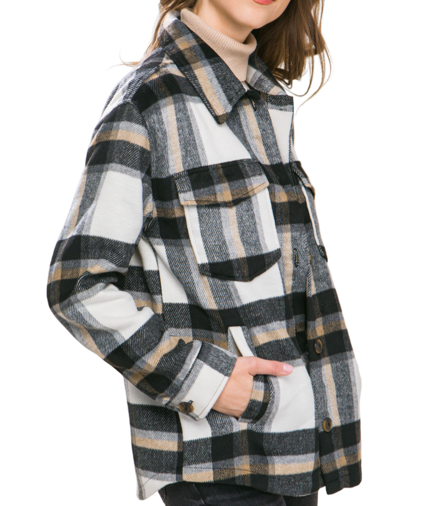 Woman wearing a plaid coat against a plain background