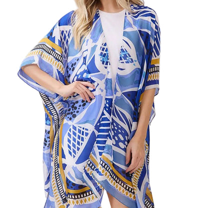 Woman wearing a blue patterned kimono-style garment on a white background