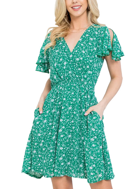 Woman wearing a green floral dress against a white background