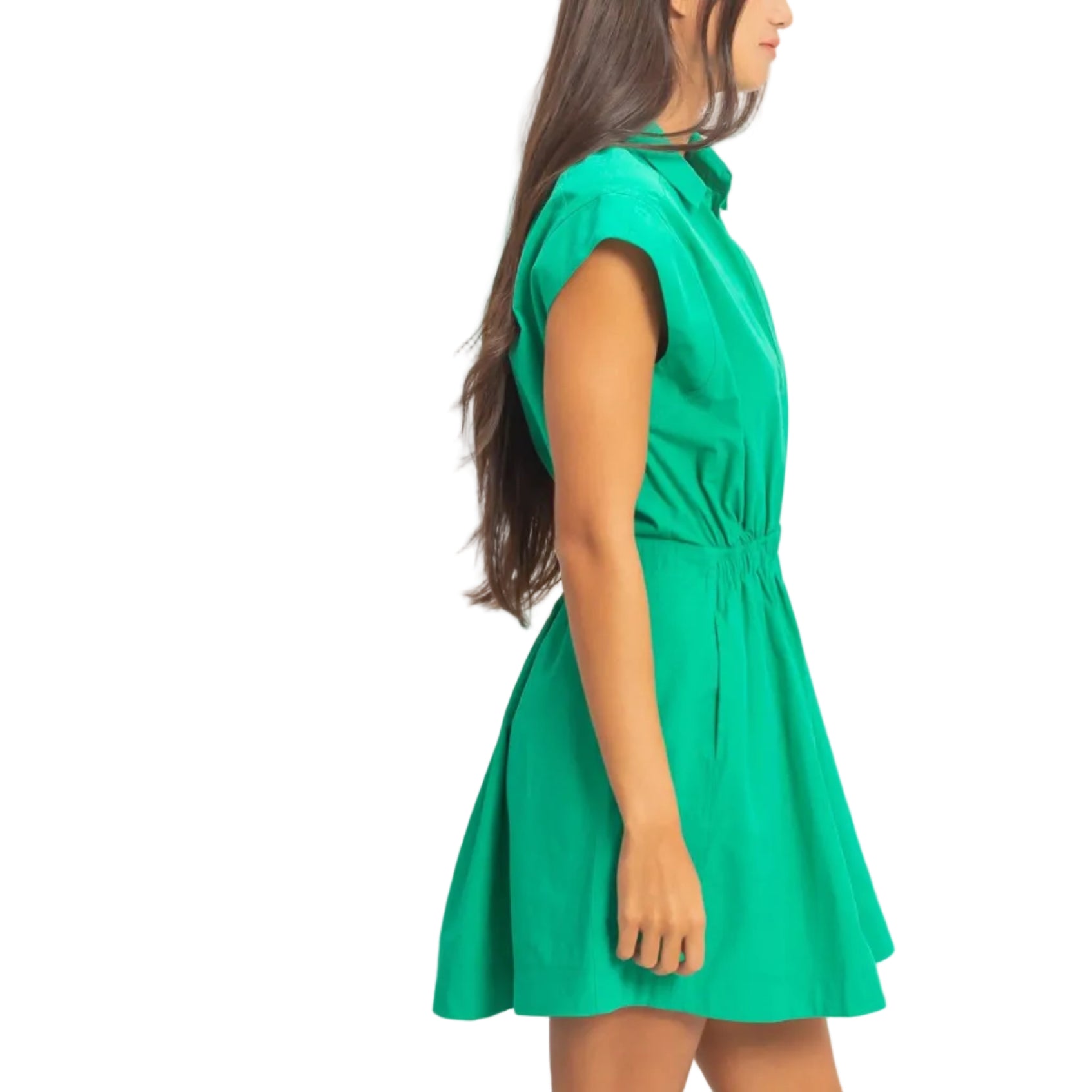 Woman wearing a green dress against a plain background