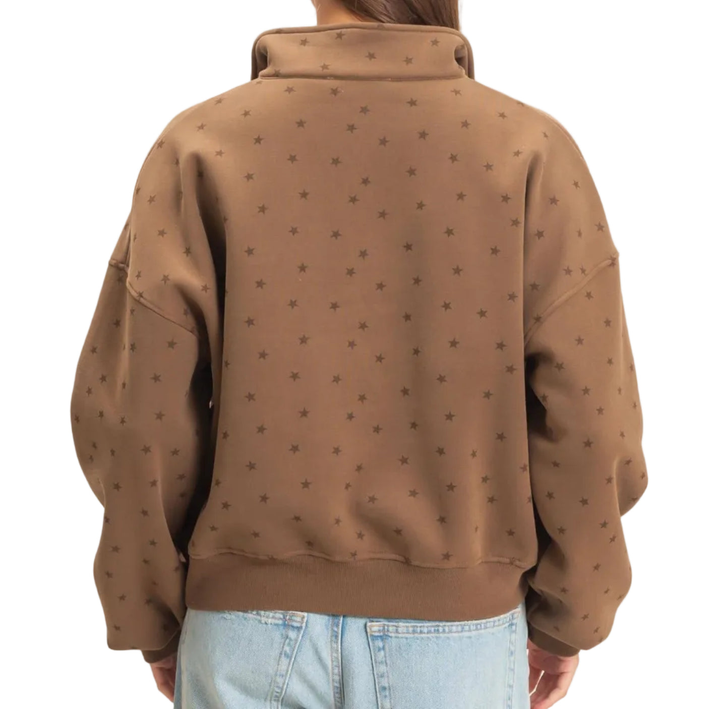 A woman viewed from behind wearing a brown cropped sweatshirt with a subtle repeating star pattern and light-wash blue jeans, set against a plain off-white background.