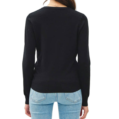 Person wearing a black long-sleeve top and light blue jeans on a white background