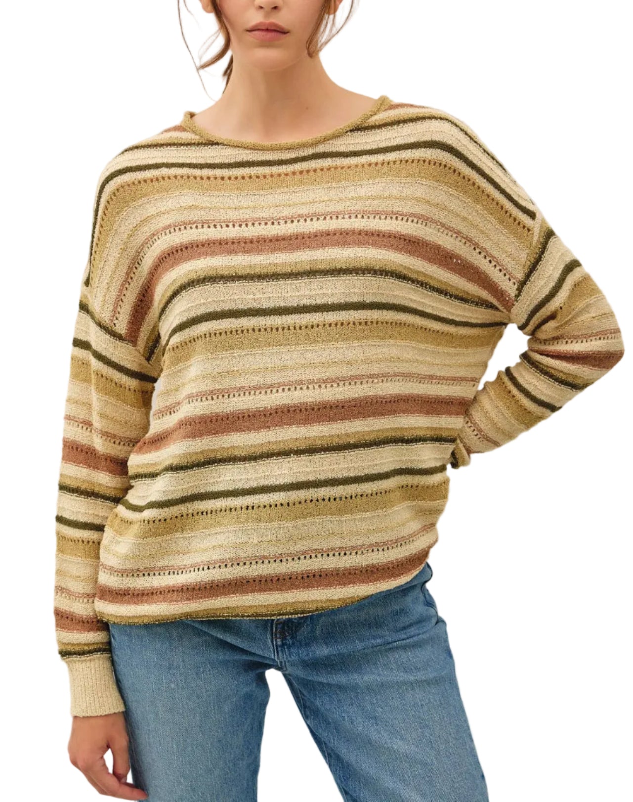 Woman wearing a striped sweater and jeans against a plain background