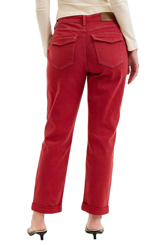 Red pants worn by a person on a plain background