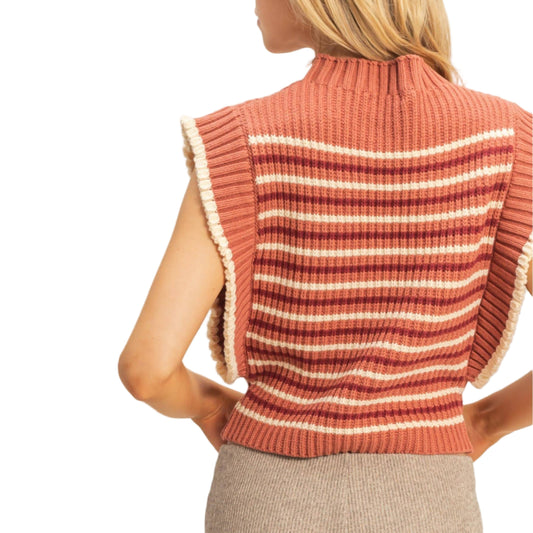 Woman wearing a striped ribbed sweater vest against a plain background