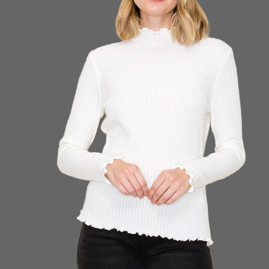 Woman wearing a white sweater against a plain background