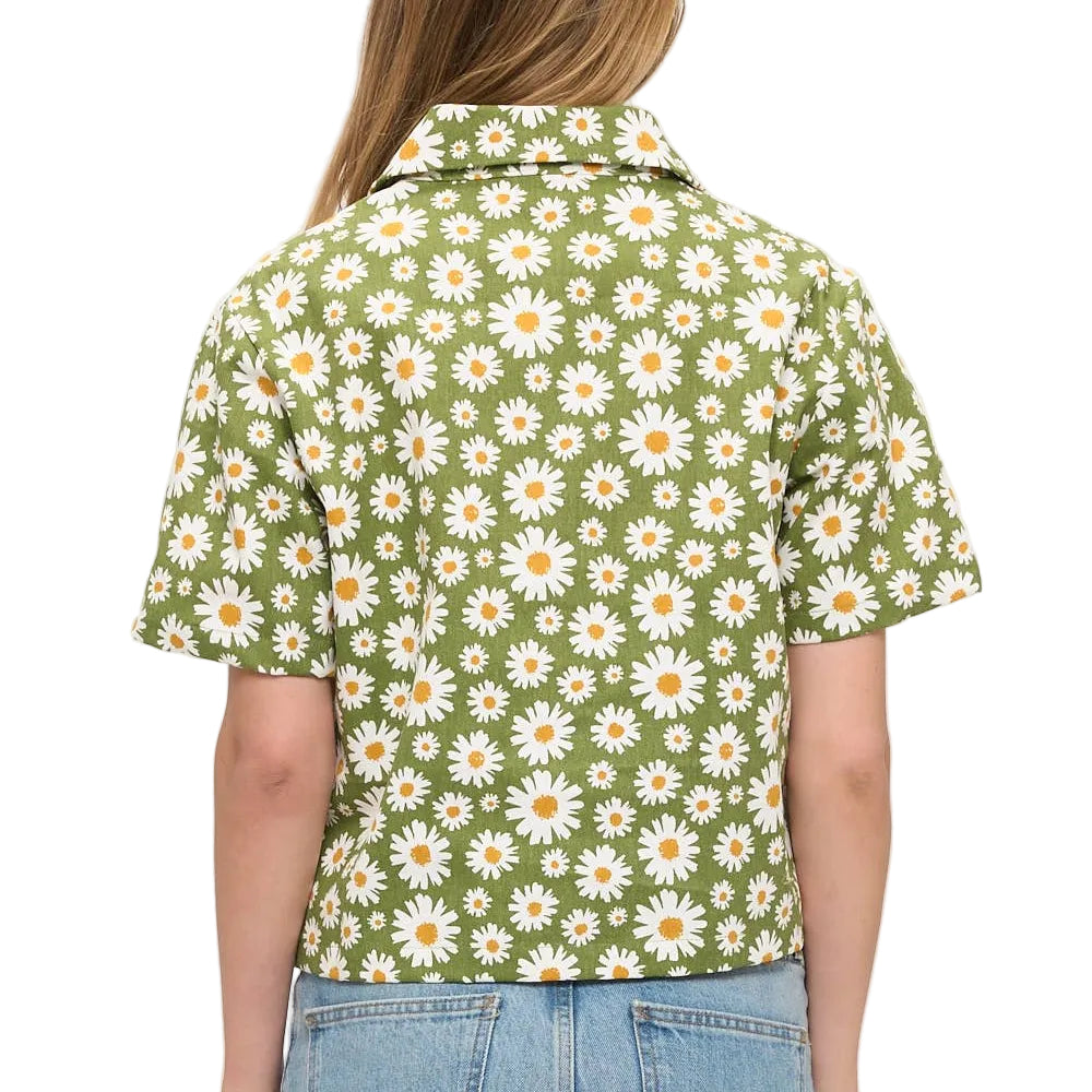Person wearing a green floral shirt with daisies on a white background