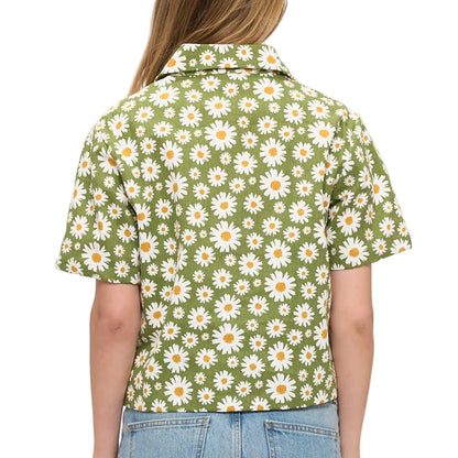 Person wearing a green floral shirt with daisies on a white background