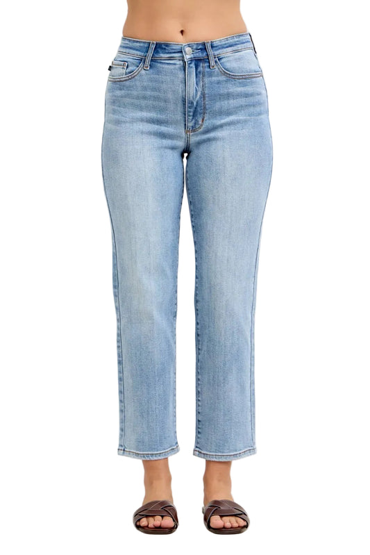 Light blue jeans worn by a person on a plain background