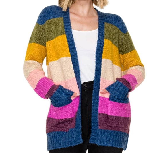 Woman wearing a colorful striped cardigan on a plain background