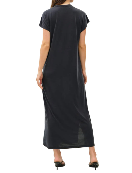Woman wearing a black dress against a white background