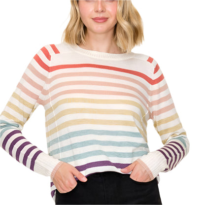 Woman wearing a colorful striped sweater against a plain background