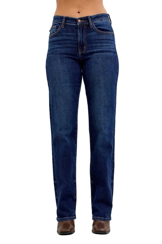 Blue jeans worn by a person on a plain background