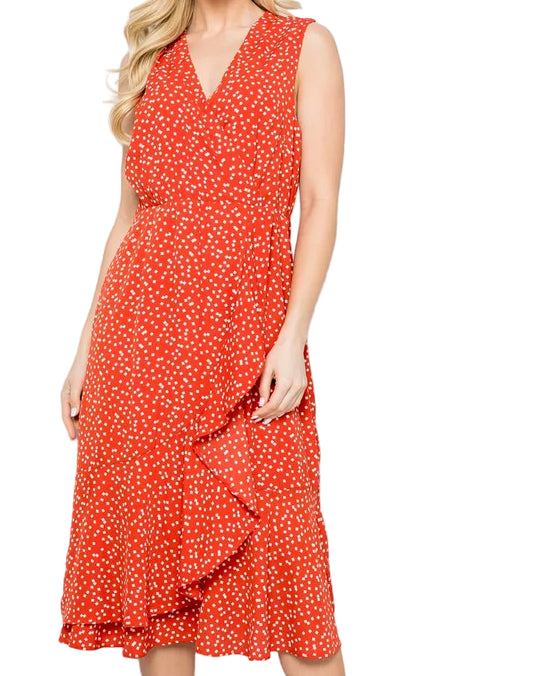 Woman wearing a red polka dot dress against a white background