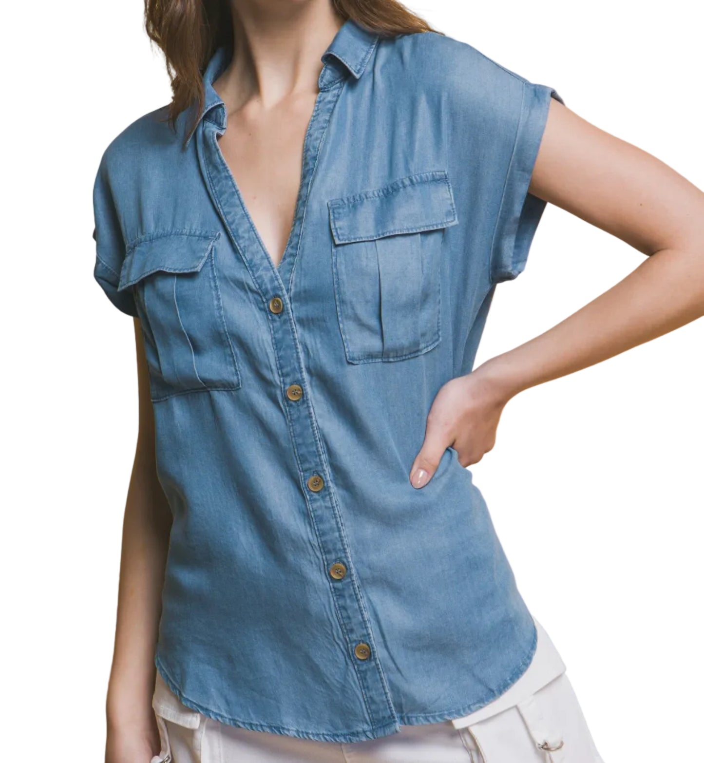 Woman wearing a blue denim shirt against a beige background