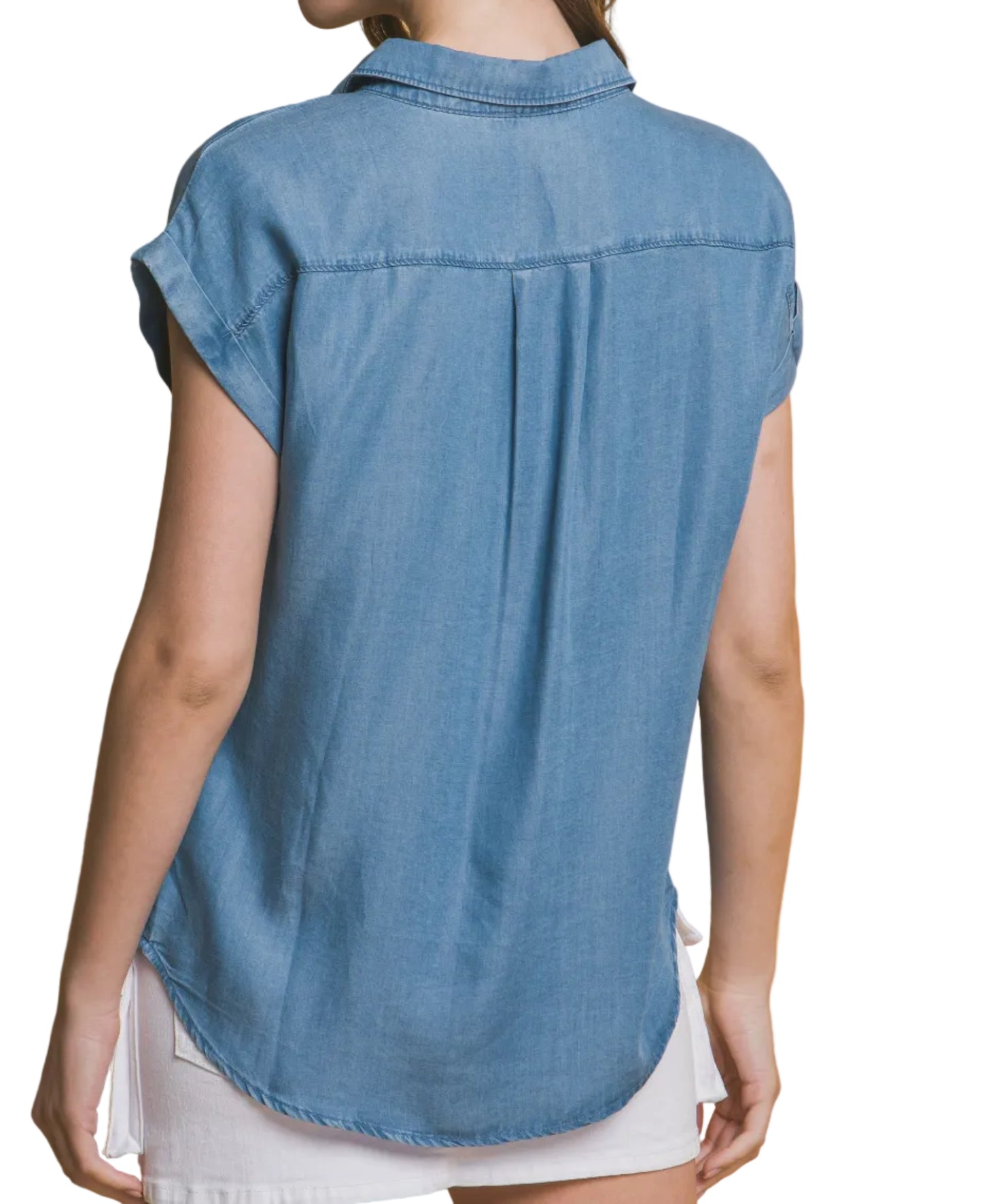 Woman wearing a blue denim shirt against a beige background