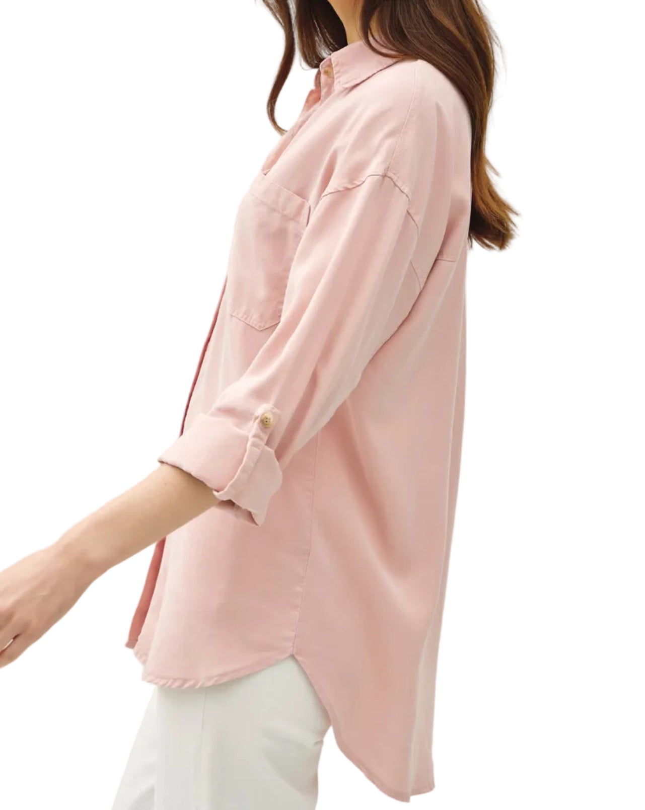 Woman wearing a light pink blouse against a white background