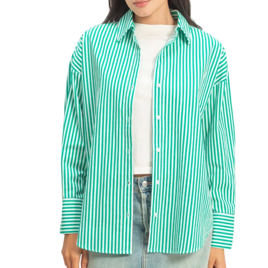 Woman wearing a green and white striped shirt on a plain background