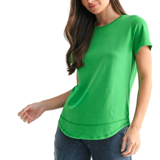 Woman wearing a green t-shirt and blue jeans on a white background
