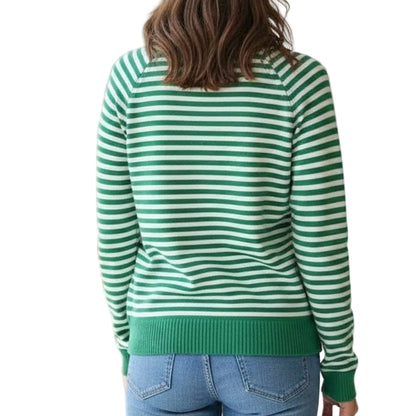 Person wearing a green and white striped sweater in a room with a neutral background