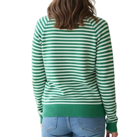 Person wearing a green and white striped sweater in a room with a neutral background