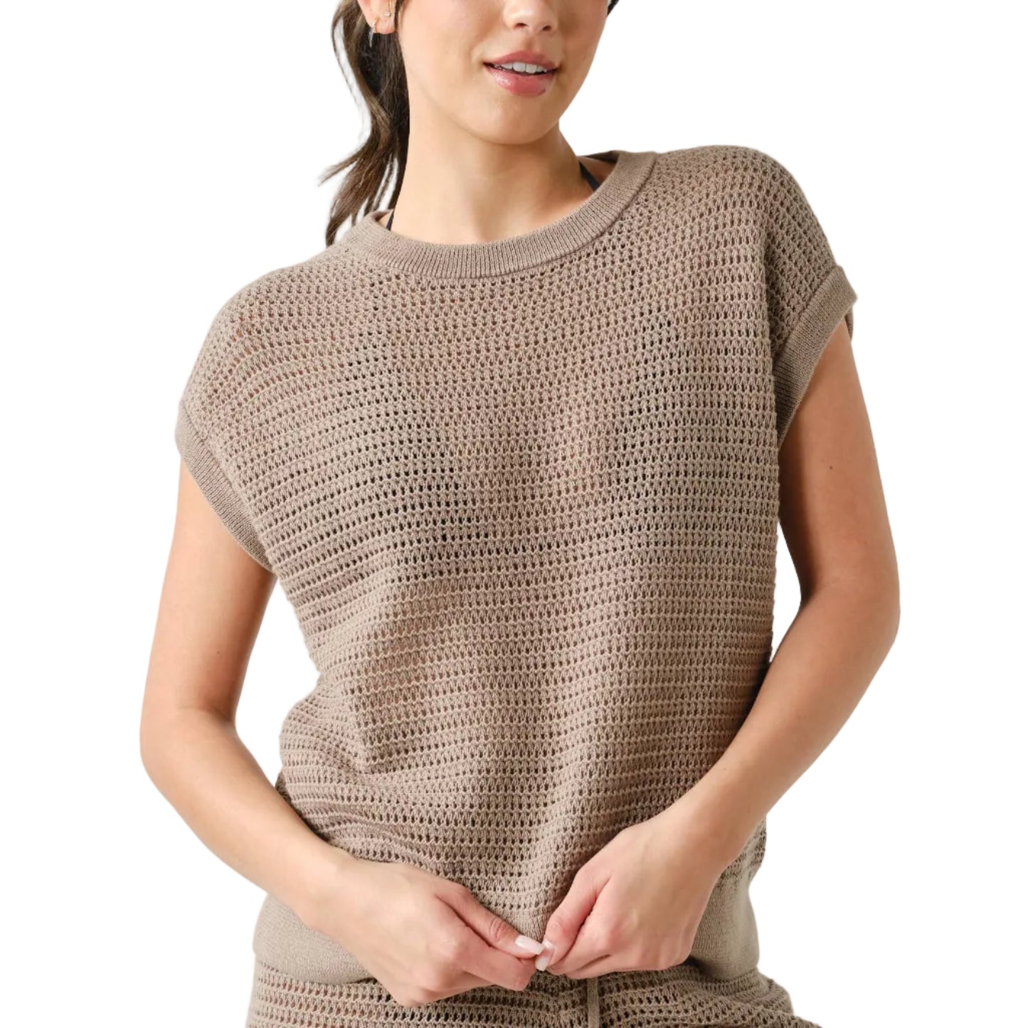 Woman wearing a brown crochet top and shorts set on a white background