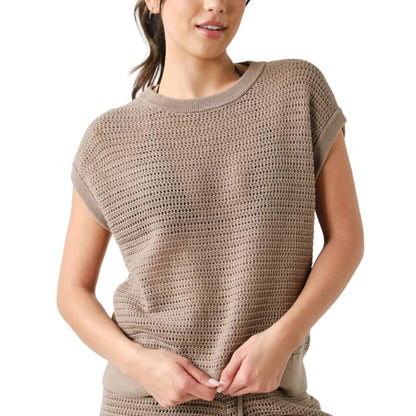 Woman wearing a brown crochet top and shorts set on a white background